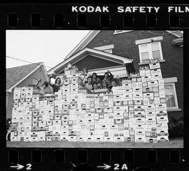 Group of guys, with 250 empty cases of beer, Charles Street, Kitchener